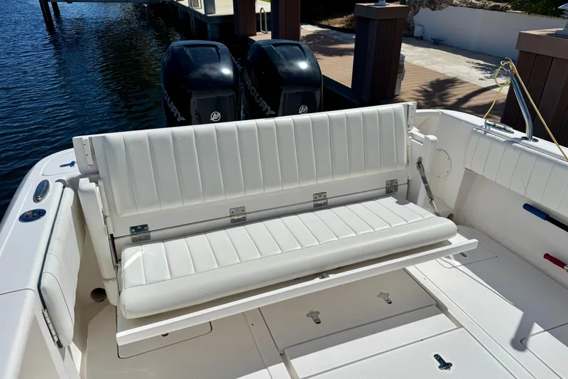 Slide: The Image of 2014 Intrepid 327 Center Console boat with white seating and dual Mercury engines. - 12