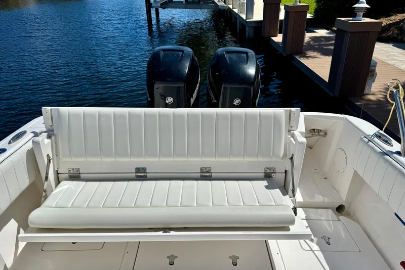 Slide: The Image of 2014 Intrepid 327 Center Console boat with white seating and dual outboard motors. - 14