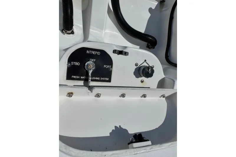 Slide: The Image of 2014 Intrepid 327 Center Console fresh water flushing system control panel. - 19