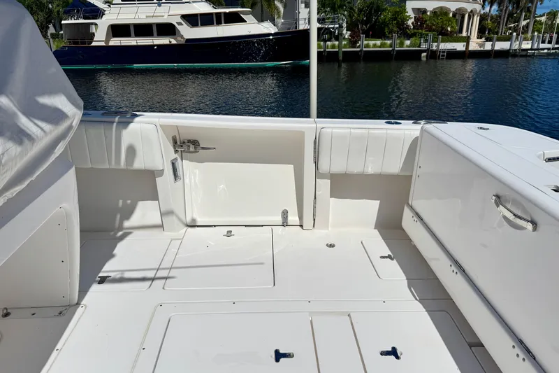 Slide: The Image of 2014 Intrepid 327 Center Console boat interior with docked yacht in background. - 22