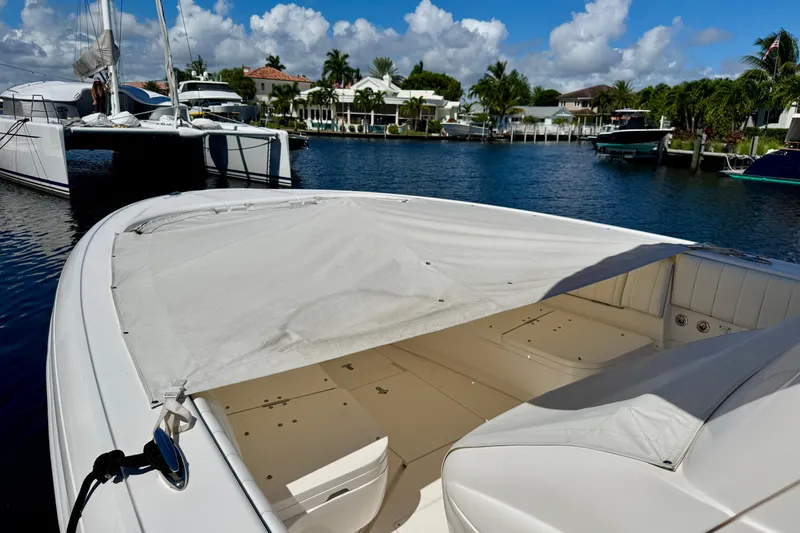 Slide: The Image of 2014 Intrepid 327 Center Console boat docked in a scenic marina. - 24