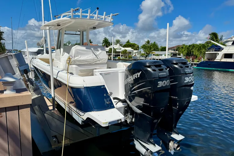 Slide: The Image of 2014 Intrepid 327 Center Console boat with twin Mercury 300 engines docked in marina. - 4