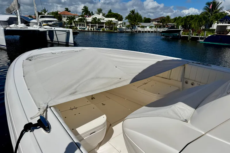 Slide: The Image of 2014 Intrepid 327 Center Console boat docked in a scenic marina. - 7