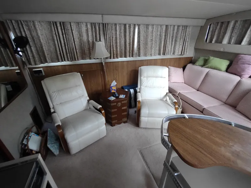 Slide: The Image of Interior of 1987 Chris-Craft 381 Catalina with plush seating and wooden accents. - 18