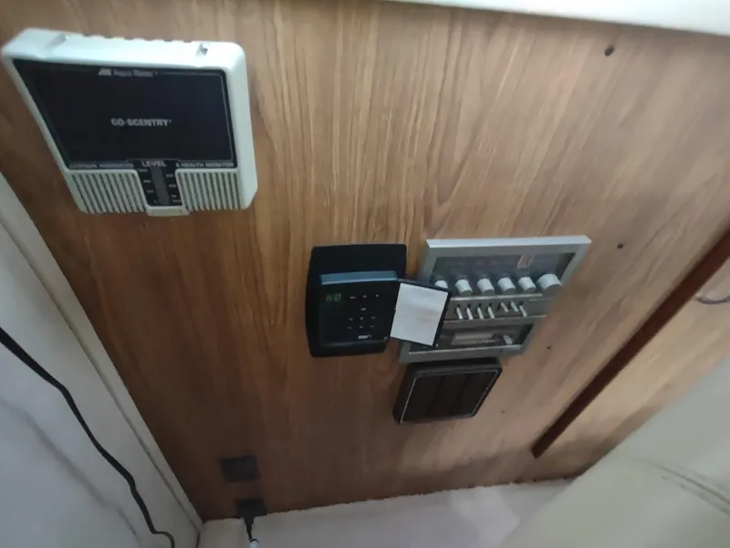 Slide: The Image of Control panel on 1987 Chris-Craft 381 Catalina boat with various switches and devices. - 19