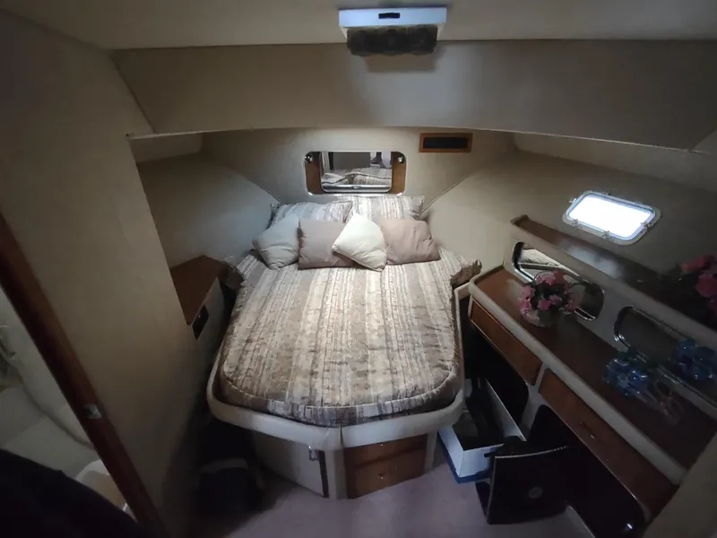 Slide: The Image of 1987 Chris-Craft 381 Catalina cabin interior with bed, storage, and window. - 22
