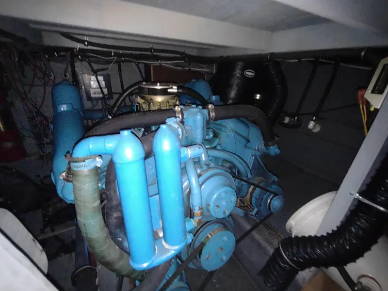 Slide: The Image of Engine room of 1987 Chris-Craft 381 Catalina with blue machinery and hoses. - 34