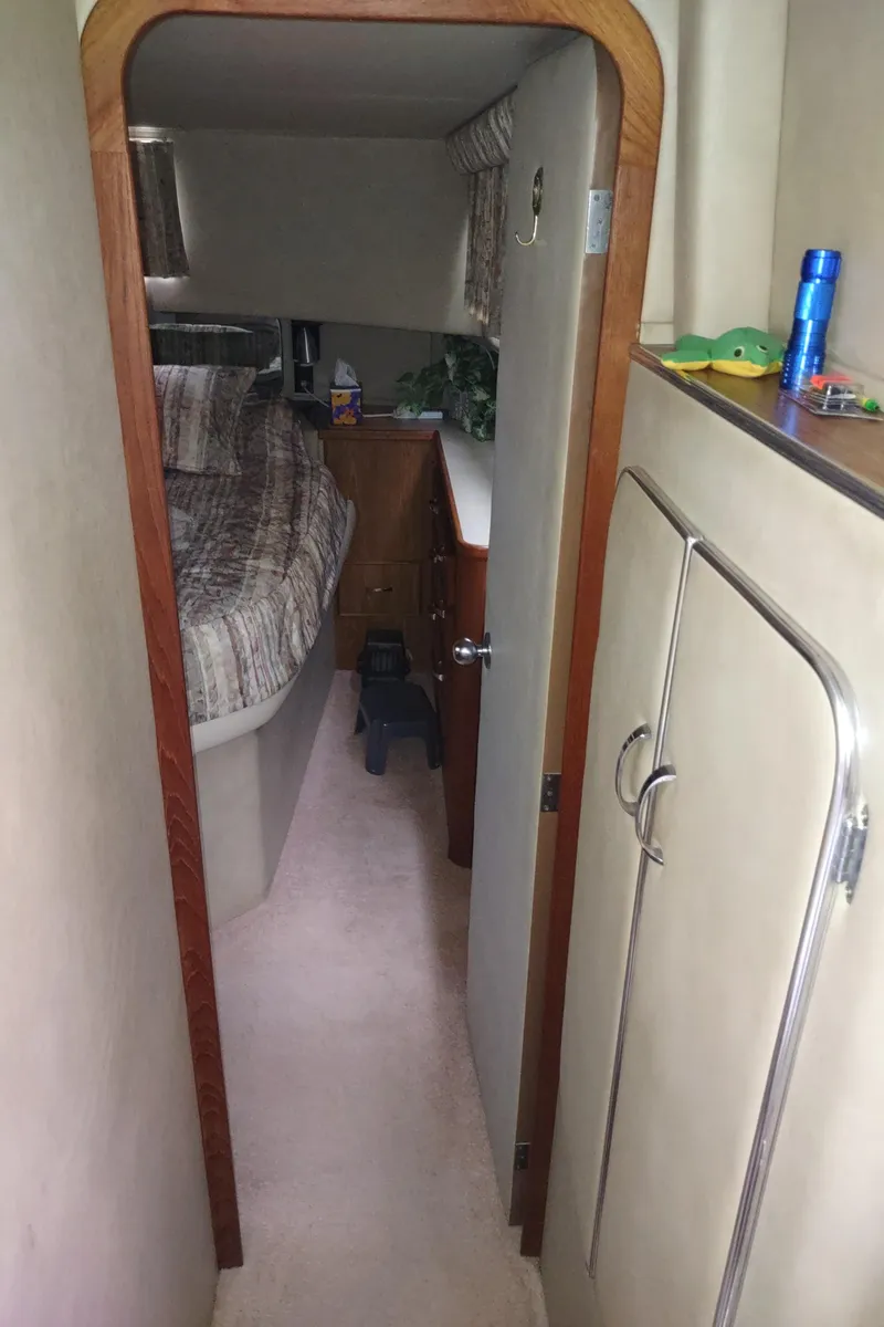 Slide: The Image of 1987 Chris-Craft 381 Catalina cabin interior with bed, storage, and compact design. - 38