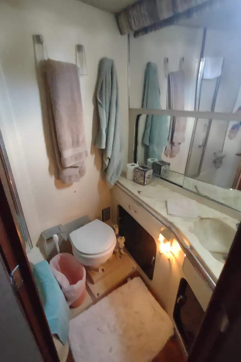 Slide: The Image of 1987 Chris-Craft 381 Catalina bathroom with towels, mirror, and sink. - 39