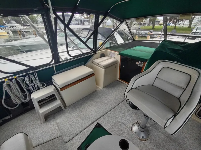 Slide: The Image of Interior of 1987 Chris-Craft 381 Catalina boat with seating and helm, docked at marina. - 7