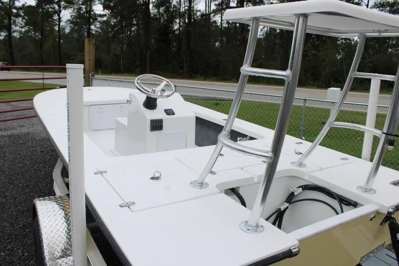 Slide: The Image of 2026 Mitzi Skiffs 17 Tournament boat rear view on gravel surface. - 6