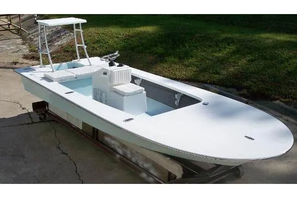 Slide: The Image of 2026 Mitzi Skiffs 17 Tournament boat on trailer, parked outdoors. - 7