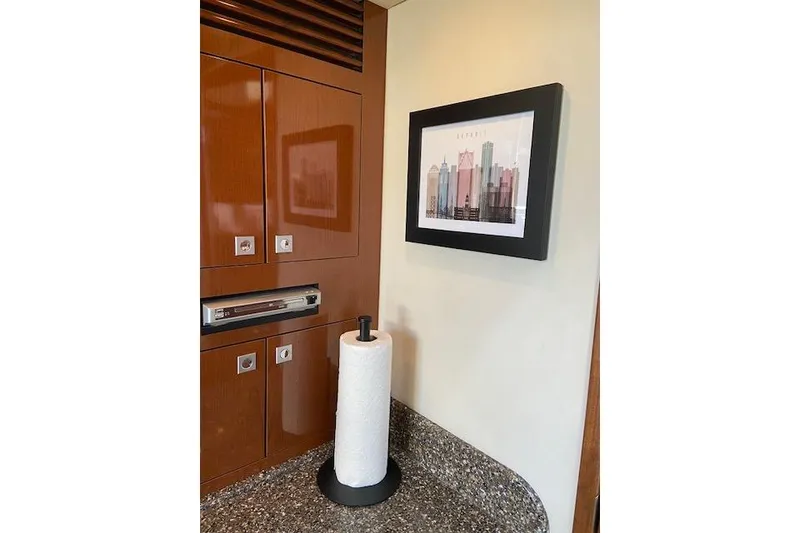 Slide: The Image of Interior of 2008 Sea Ray 400 Sundancer with wood cabinets and framed artwork. - 14