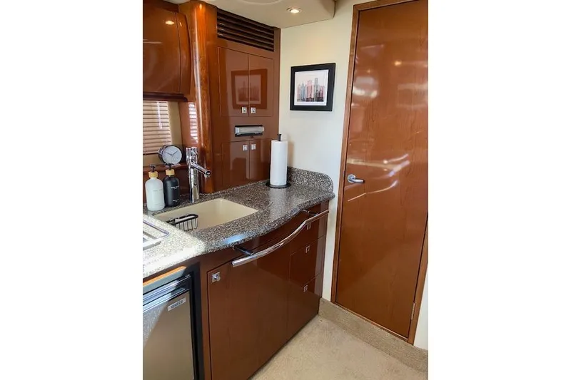 Slide: The Image of Interior of 2008 Sea Ray 400 Sundancer yacht with modern kitchen amenities. - 15