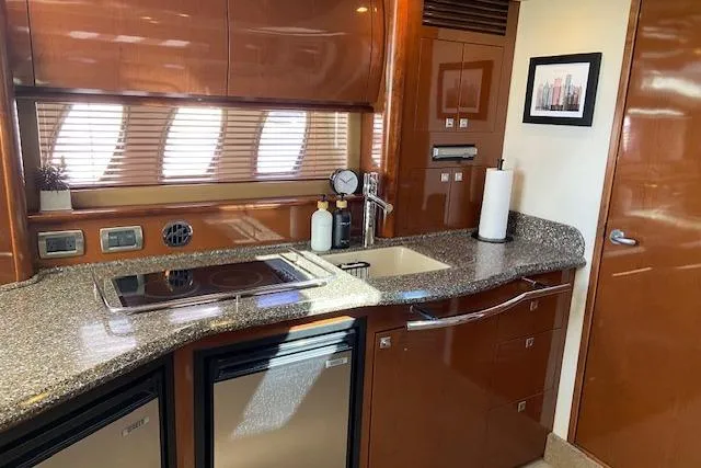 Slide: The Image of Luxurious kitchen interior of 2008 Sea Ray 400 Sundancer yacht with modern amenities. - 16