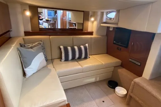 Slide: The Image of Interior of 2008 Sea Ray 400 Sundancer yacht with beige seating and decorative pillows. - 18
