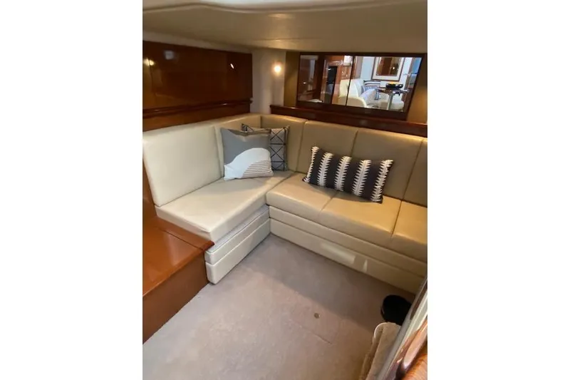 Slide: The Image of Interior of 2008 Sea Ray 400 Sundancer with beige leather seating and decorative pillows. - 19