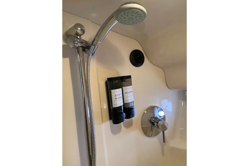 Slide: The Image of Shower area in 2008 Sea Ray 400 Sundancer with mounted body wash and shampoo dispensers. - 20