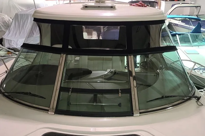 Slide: The Image of 2008 Sea Ray 400 Sundancer yacht with sleek windshield design in a marina setting. - 3