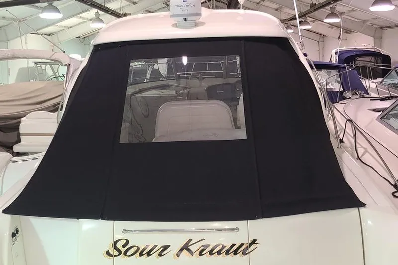 Slide: The Image of 2008 Sea Ray 400 Sundancer yacht with black canvas cover in a marina. - 6
