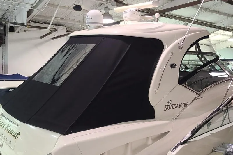 Slide: The Image of 2008 Sea Ray 400 Sundancer yacht with black canvas cover in indoor storage. - 7