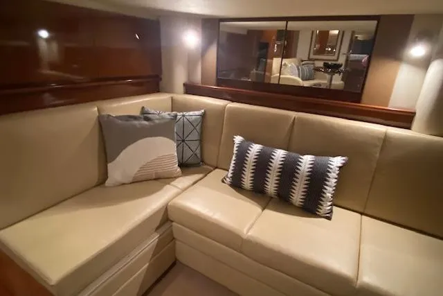 Slide: The Image of Interior of 2008 Sea Ray 400 Sundancer with beige leather seating and decorative pillows. - 9