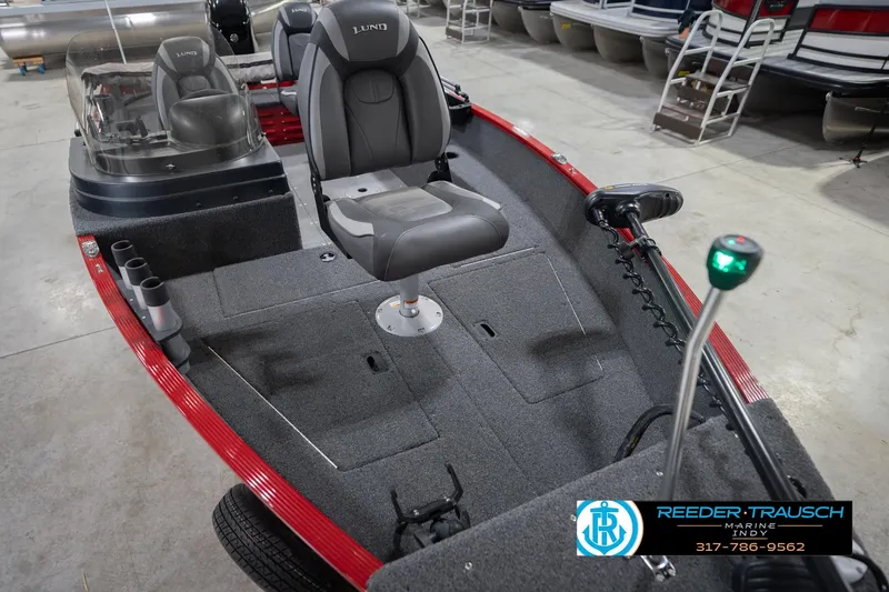 Slide: The Image of 2023 Lund 1650 Angler SS fishing boat interior with seating and equipment in showroom. - 13