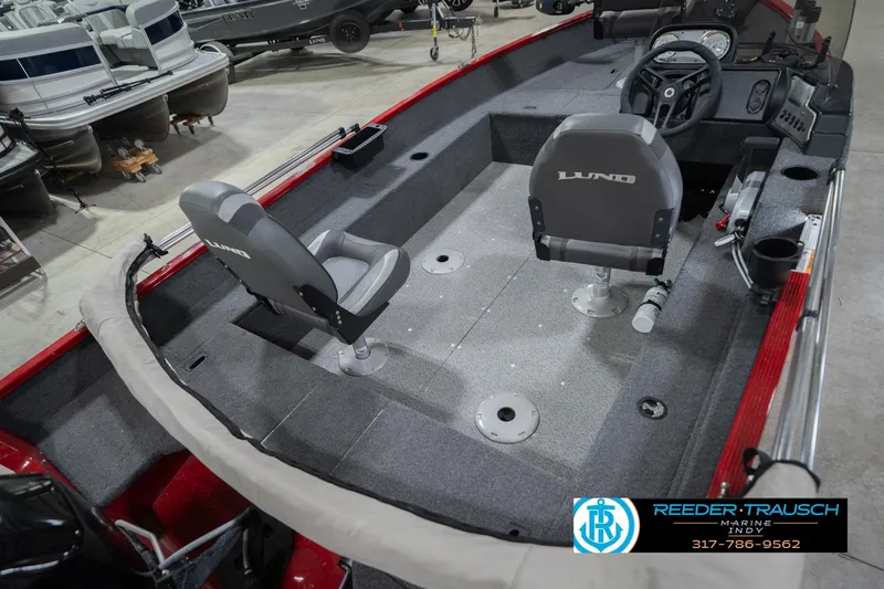 Slide: The Image of 2023 Lund 1650 Angler SS boat interior with seating and steering console. - 14