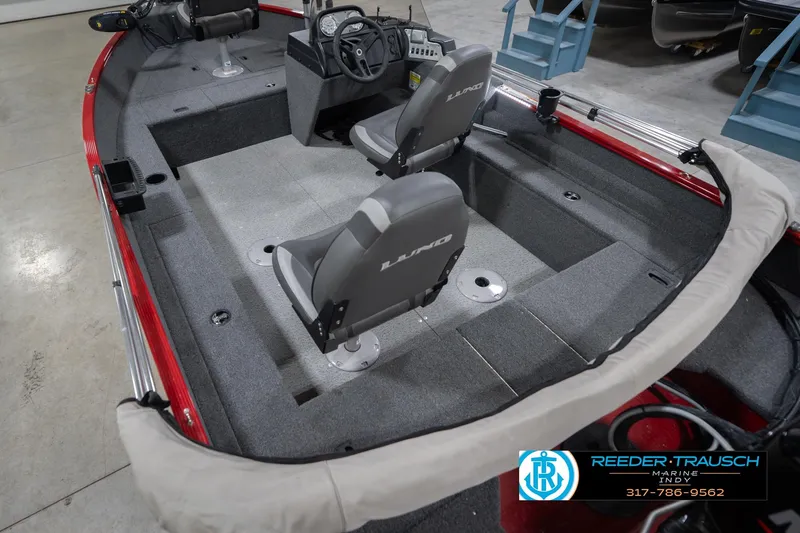 Slide: The Image of 2023 Lund 1650 Angler SS boat interior with gray seating and steering console. - 15