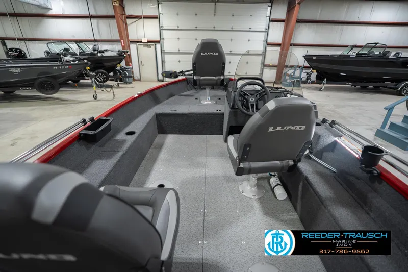 Slide: The Image of 2023 Lund 1650 Angler SS boat interior with steering console in showroom. - 16