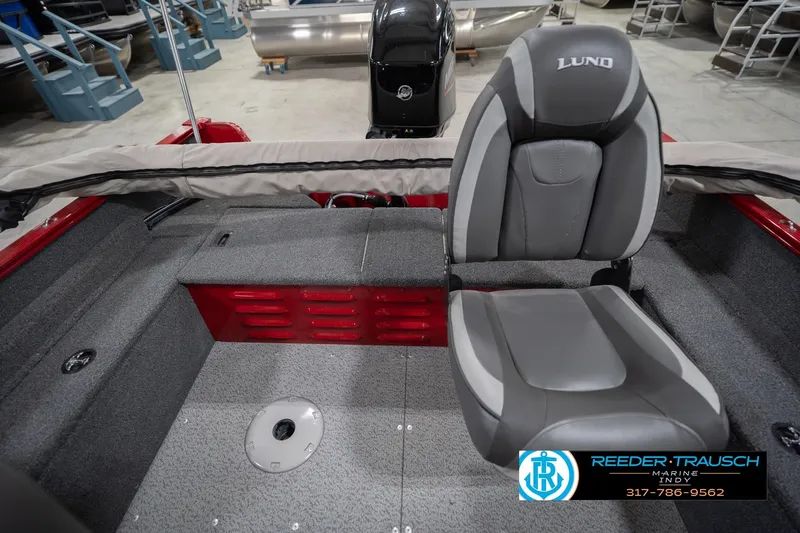 Slide: The Image of 2023 Lund 1650 Angler SS boat interior with gray seating and red accents. - 21