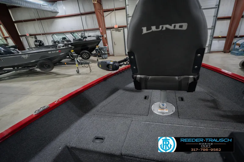 Slide: The Image of 2023 Lund 1650 Angler SS boat interior with seating in a showroom. - 24