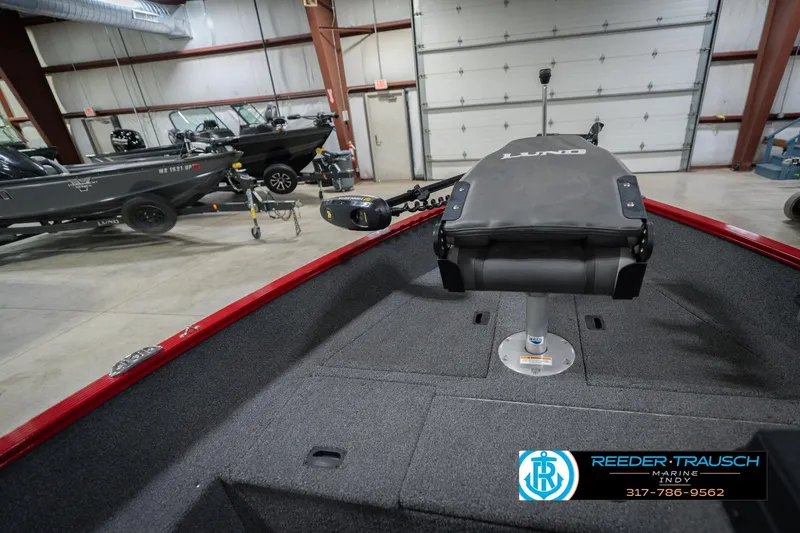 Slide: The Image of 2023 Lund 1650 Angler SS boat interior in showroom, featuring fishing seat and equipment. - 25