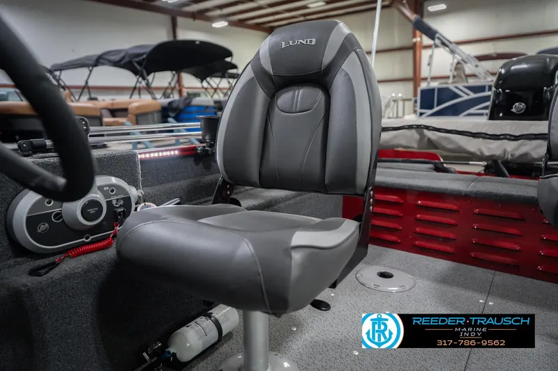 Slide: The Image of 2023 Lund 1650 Angler SS boat interior with steering console and seating. - 35