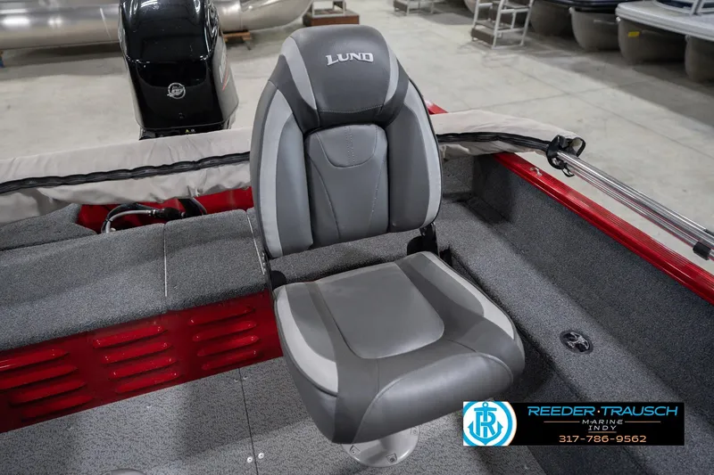 Slide: The Image of 2023 Lund 1650 Angler SS boat seat in showroom, featuring gray upholstery and sleek design. - 37