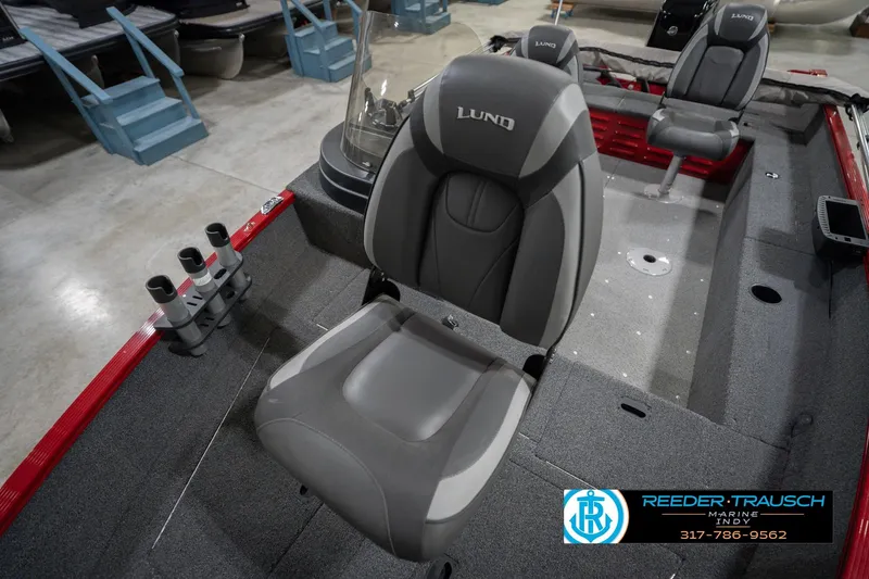 Slide: The Image of 2023 Lund 1650 Angler SS boat interior with gray seating and rod holders. - 38