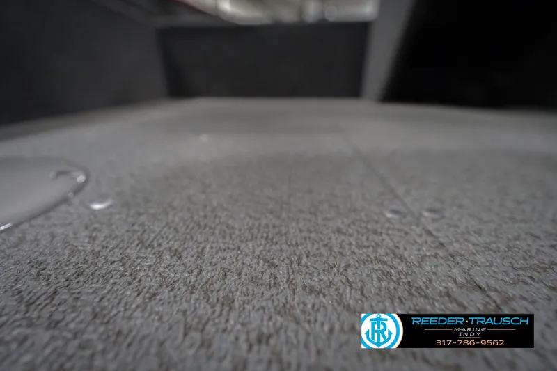 Slide: The Image of 2023 Lund 1650 Angler SS boat interior with carpeted flooring, Reeder-Trausch Marine logo. - 40