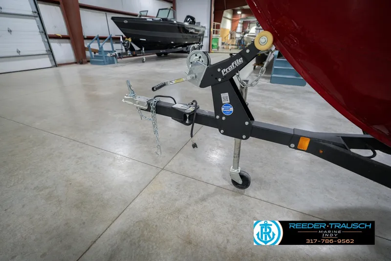 Slide: The Image of 2023 Lund 1650 Angler SS boat trailer in showroom, Reeder-Trausch Marine logo visible. - 50