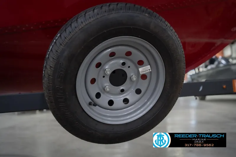 Slide: The Image of 2023 Lund 1650 Angler SS trailer wheel, close-up view in showroom. - 53