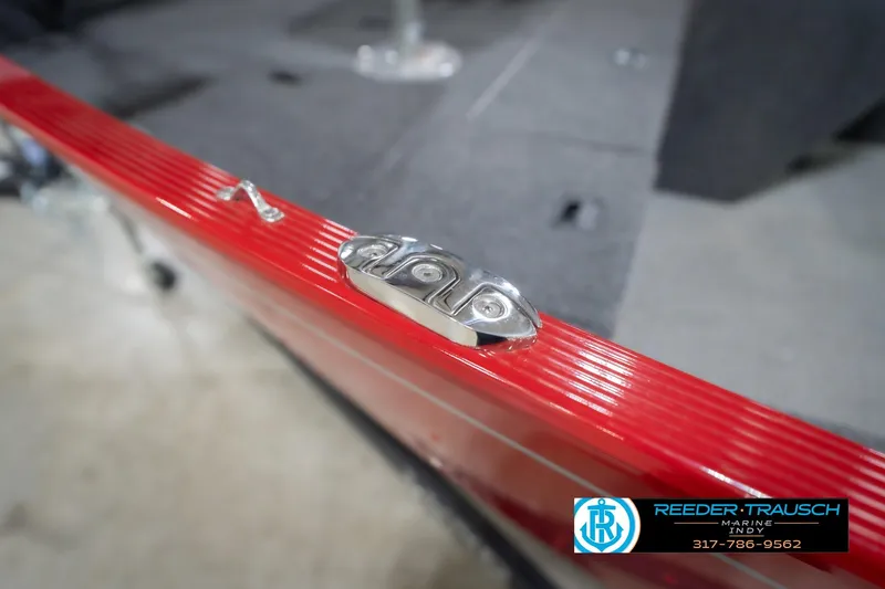 Slide: The Image of 2023 Lund 1650 Angler SS boat detail with red trim and metal fixture. - 56