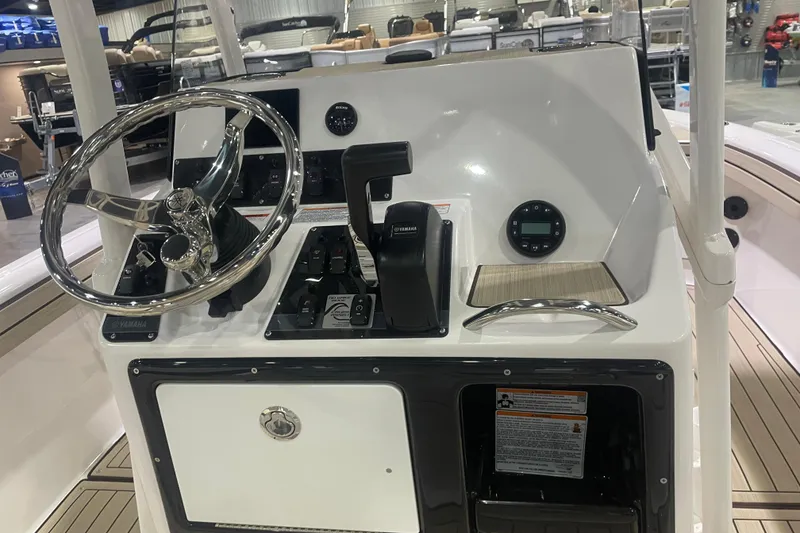 Slide: The Image of 2025 Yamaha Boats 195 FSH Sport dashboard with steering wheel and controls. - 4