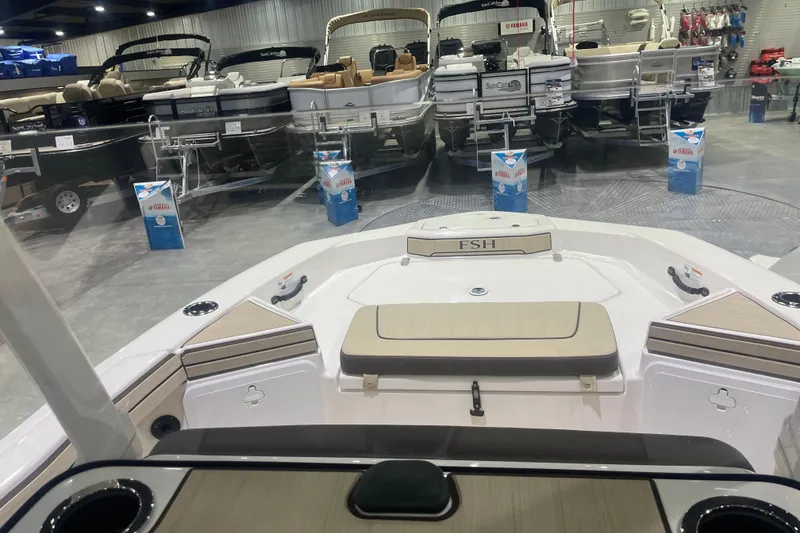 Slide: The Image of 2025 Yamaha Boats 195 FSH Sport displayed in a showroom with other boats. - 5
