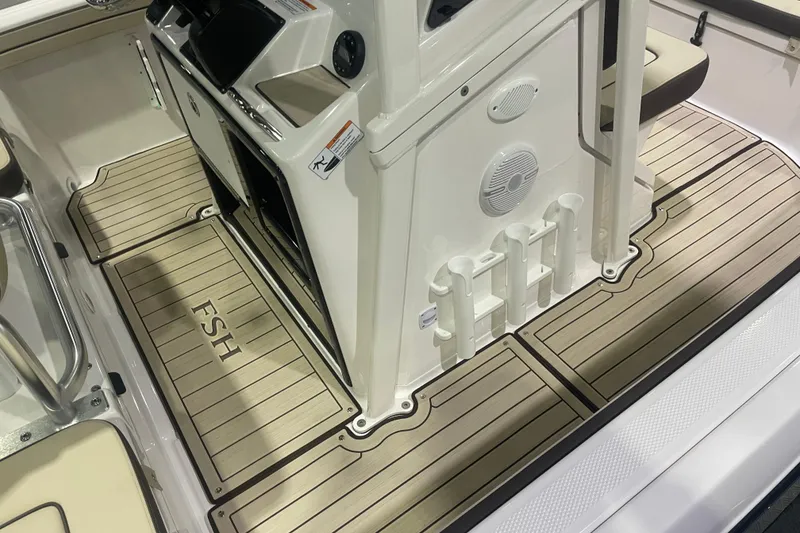 Slide: The Image of 2025 Yamaha Boats 195 FSH Sport interior with sleek deck design and integrated rod holders. - 6