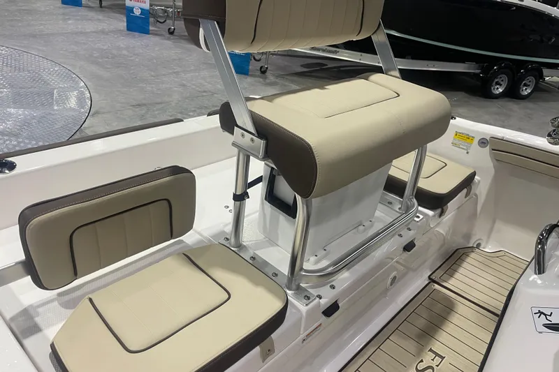 Slide: The Image of 2025 Yamaha Boats 195 FSH Sport interior with beige seating and sleek design. - 7