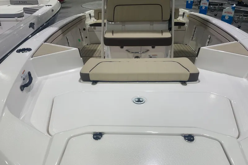 Slide: The Image of 2025 Yamaha Boats 195 FSH Sport interior with beige seating and spacious deck layout. - 8