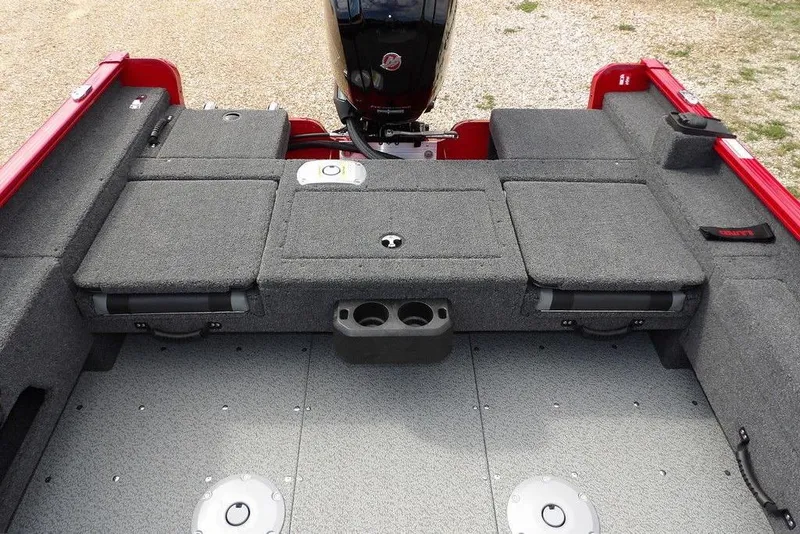 Slide: The Image of 2026 Lund 1775 Adventure Sport boat interior with gray carpet and storage compartments. - 17