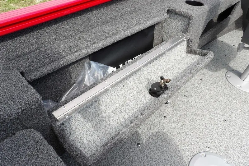 Slide: The Image of 2026 Lund 1775 Adventure Sport boat interior with storage compartment and carpeted flooring. - 18