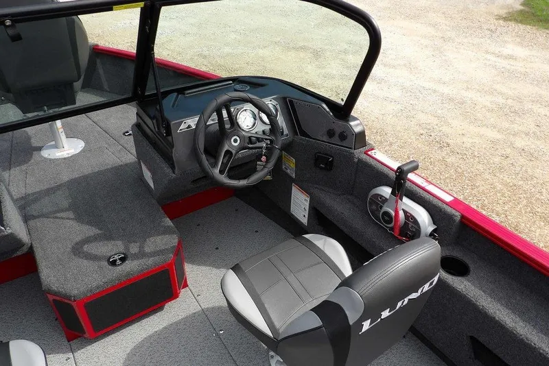 Slide: The Image of 2026 Lund 1775 Adventure Sport boat interior with steering wheel and seating. - 21