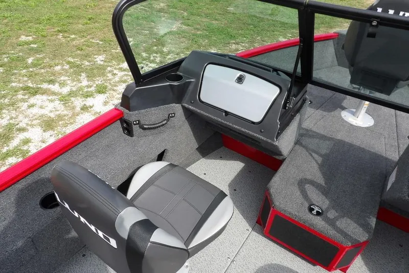 Slide: The Image of 2026 Lund 1775 Adventure Sport boat interior with seating and console, featuring red and gray accents. - 29