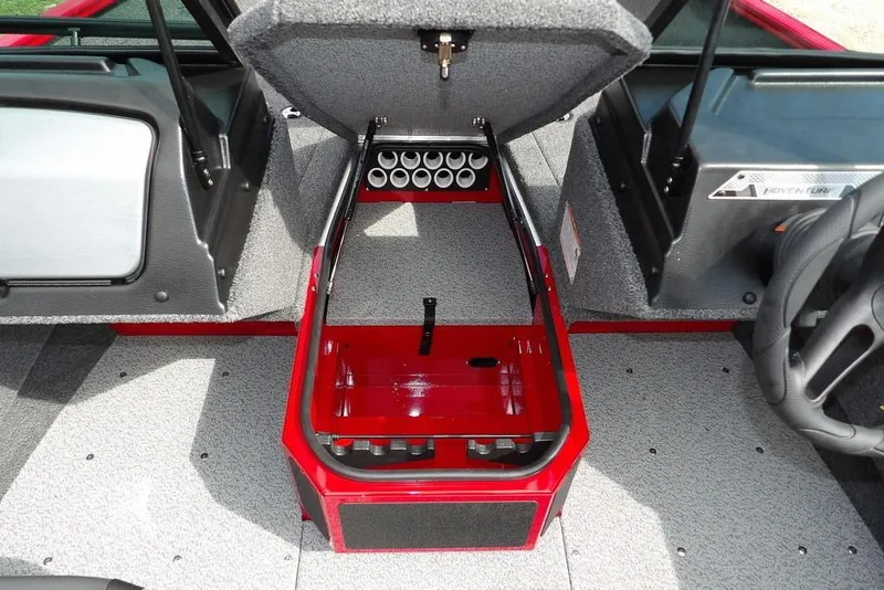 Slide: The Image of 2026 Lund 1775 Adventure Sport boat interior with open storage compartment and rod holders. - 38